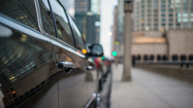 Passenger door handle of a black SUV in the city